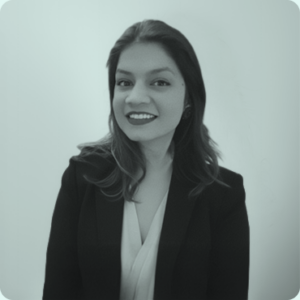 Portrait of a professional woman in a blazer, smiling against a soft, muted background, representing Olibro Design's team expertise in web development and digital strategy.