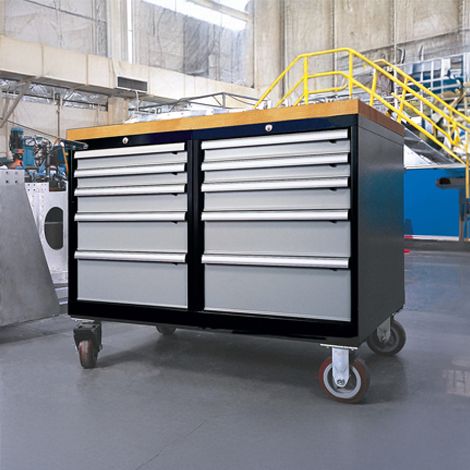 Industrial tool cabinet with multiple drawers on wheels, showcasing a functional design for organizing tools in a workshop setting.