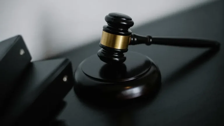 Gavel on a dark wooden surface symbolizing legal authority and compliance, relevant to website legal pages and business protection.